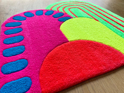 One of a kind, vibrant, hand tufted rug.