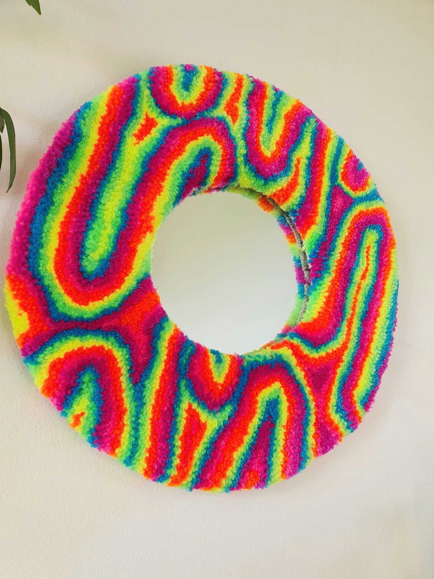 Miniature round psychedelic swirl mirror in rainbow with pink