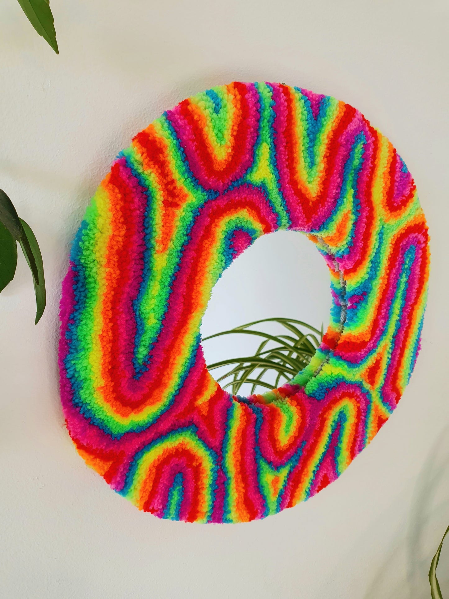 Miniature round psychedelic swirl mirror in rainbow with pink and purple accents