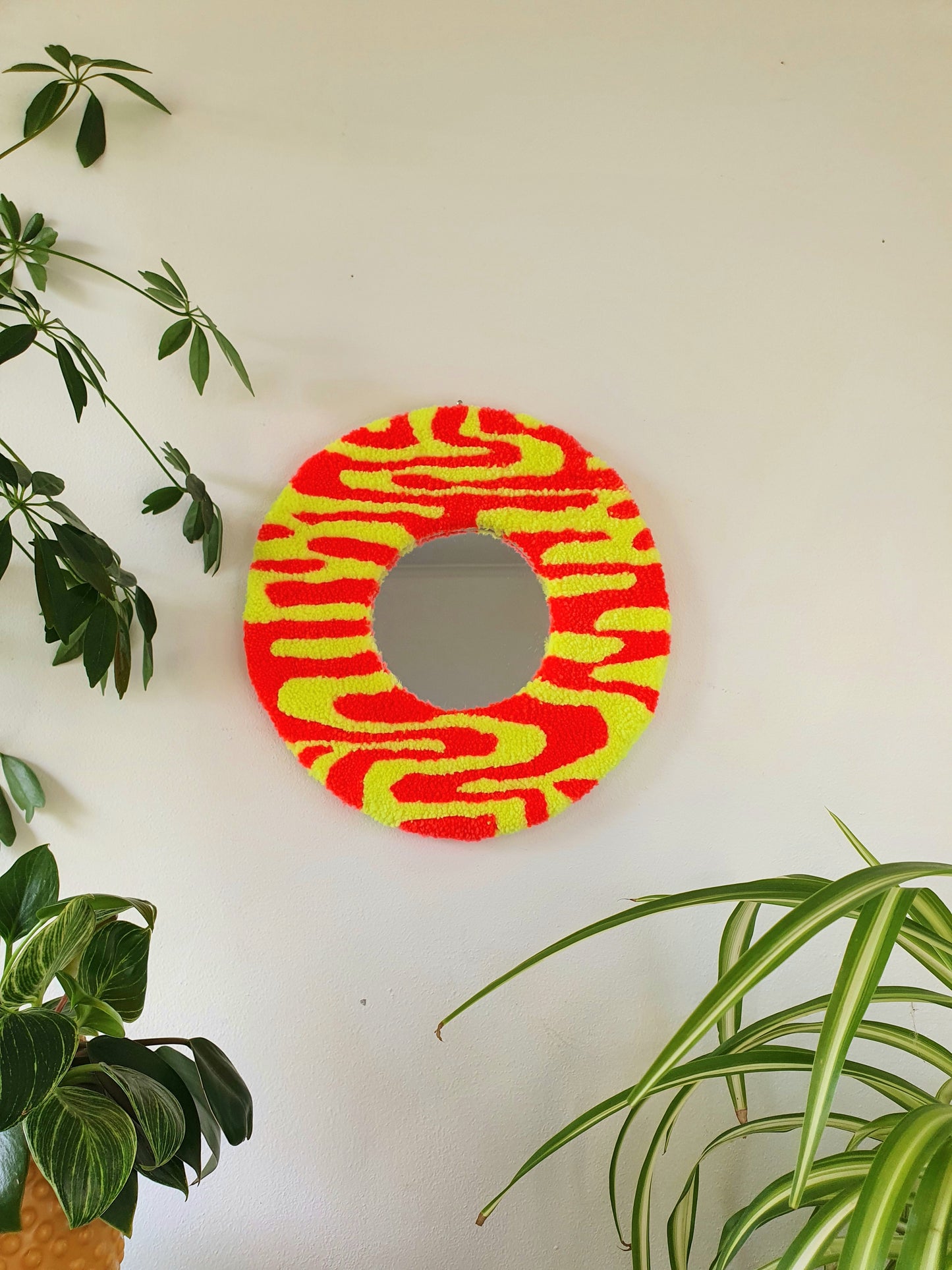 Miniature round psychedelic swirl mirror in yellows and orange